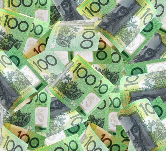 A scattered collection of Australian 100-dollar bills featuring green hues and a portrait of a historical figure.