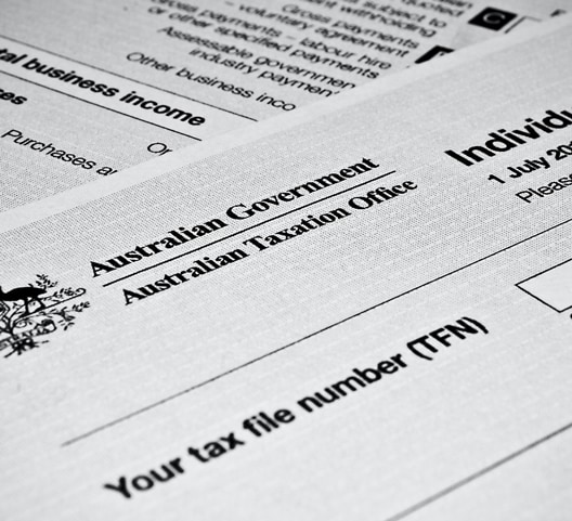 Close-up of Australian Taxation Office documents showing "Australian Government" and "Your tax file number (TFN)" headings on a tax form.