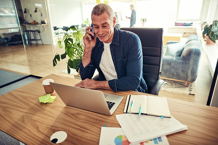 Business advisor speaking with a client at a desk, reflecting a lifestyle business client limit